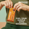 Person holding an 'upnourish' protein bar with promotional text on a green background