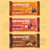 Three Upnourish plant protein bars on a yellow background with illustrations of fruits and nuts.